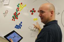 Doug Ragan in front of white board