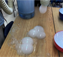 dropping bubbles from vacuum hose attached to 5 gallon jug