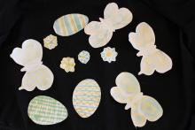 Photochromic glue applied to paper flowers, eggs and butterflies and viewed in indoor light