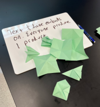 Attempted origami butterfly while texting and listening to songs on phones.