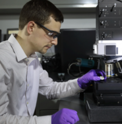 Dr. Eaton using microscope