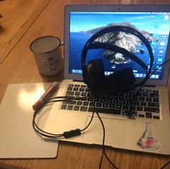 open laptop, mug, headphones