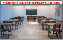 view from behind empty desks and a teacher desk with chalkboard at front of room