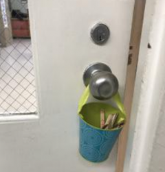 door know with can of crayons hanging from it