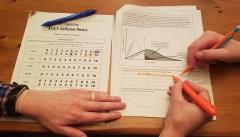 teacher working with student on a signature sheet for a learning target