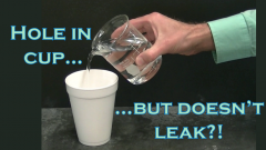 pouring clear solution into white styrofoam cup