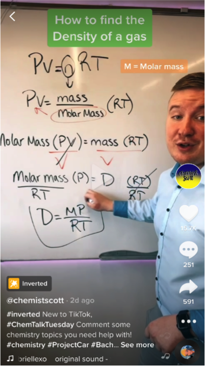 author working through a chemistry problem on the whiteboard