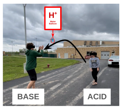 two students play Balloon Blast Brain Break game outside of school building