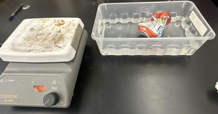 Crushing a soda can demo - crushed can in tub of water next to hotplate
