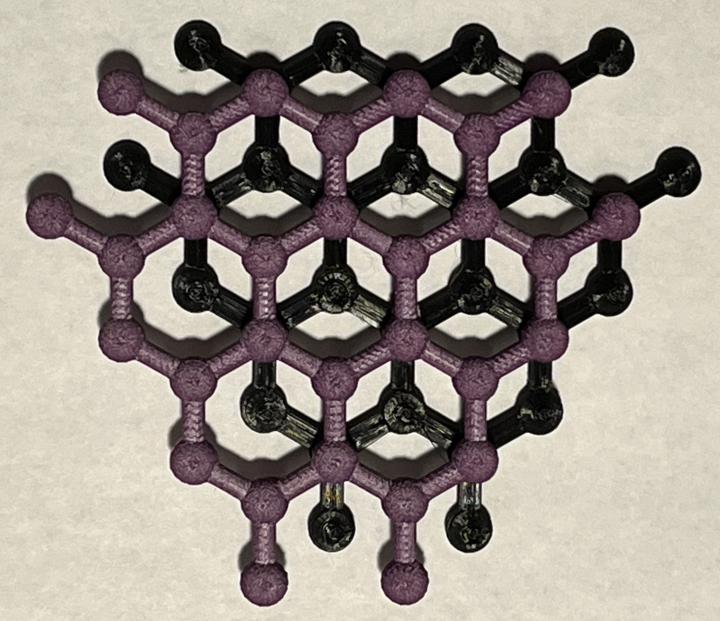 Two 3D printed models of graphene stacked above each other to represent two layers of the graphite structure.