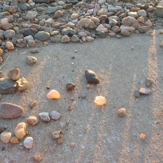 Laser interactions with opaque limestone and translucent quartzite, and sunlight illuminating quartz pebbles.