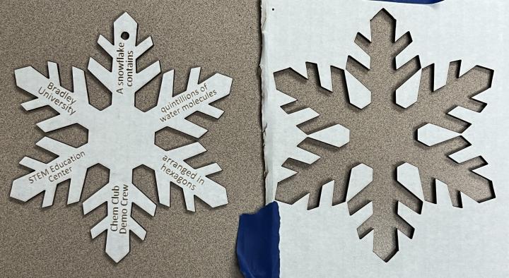 Laser cut and engraved corrugated cardboard in a snowflake shape