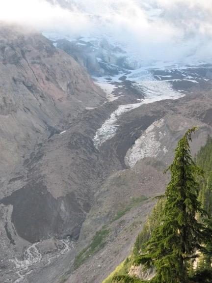 Pictures of glaciers appearing white with dark-colored debris.