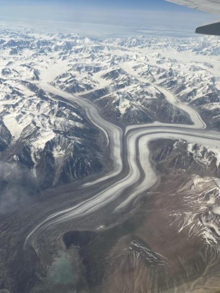 Pictures of glaciers appearing white with dark-colored debris.