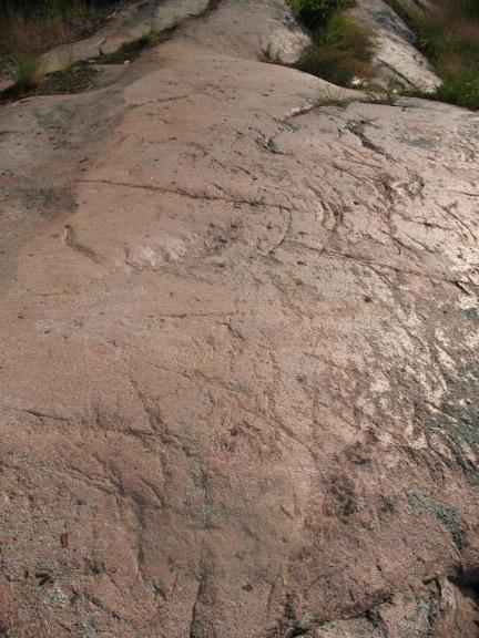  (TOP LEFT) Large boulder, (TOP RIGHT) scratches and “chatter marks” in a smooth rock formation, and (BOTTOM) holes drilled into bedrock by glacier-fed waters swirling stones in circles.