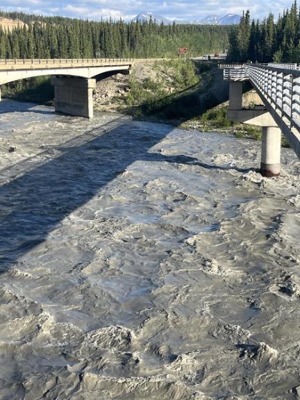 River turned opaque and gray with suspended rock particles.