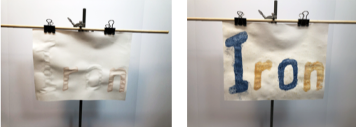 IRON written with 'invisible' potassium thiocyanate solution and potassium ferrocyanide solution on paper, then after being sprayed with iron chloride