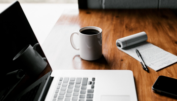 MacBook Pro on brown wooden table