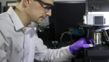 chemist using microscope