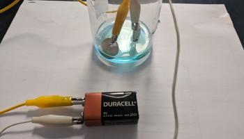 electroplating using a beaker, blue solution, copper electrode, 9V battery and alligator clips