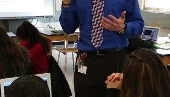 close up of teacher in front of first row of students