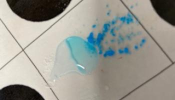 puddle of a reaction on a laminated reaction sheet