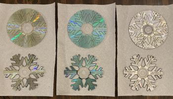 CDs cut and engraved by laser into snowflake shapes