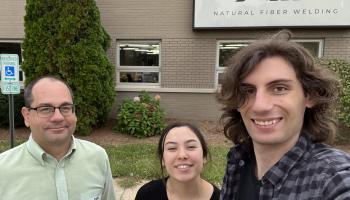 Visitors standing outside the Natural Fiber Welding, Inc. facility