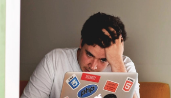 male student looking at laptop screen