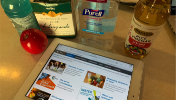 household products on kitchen counter plus iPad with RSC Global Experiment website on the screen