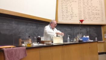 Teacher at front lab counter preparing a Demo