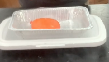 orange balloon in pan of dry ice