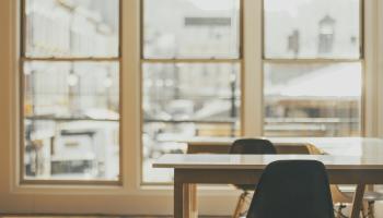 empty classroom tables with window in background