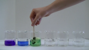beakers of different colors of solutions
