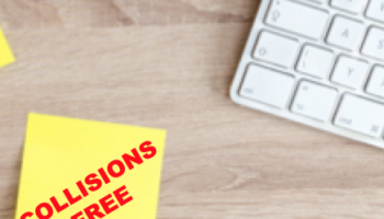 corner of computer keyboard and sticky note with text: Collisions Free 
