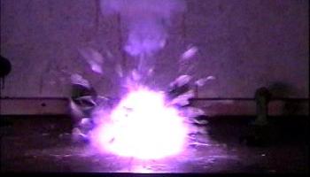 Ignition of sugar and potassium chlorate produces purple flames and sparks.