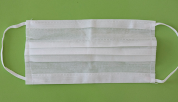 white facemark on green background