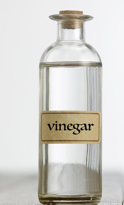 clear glass bottle labeled as "vinegar"
