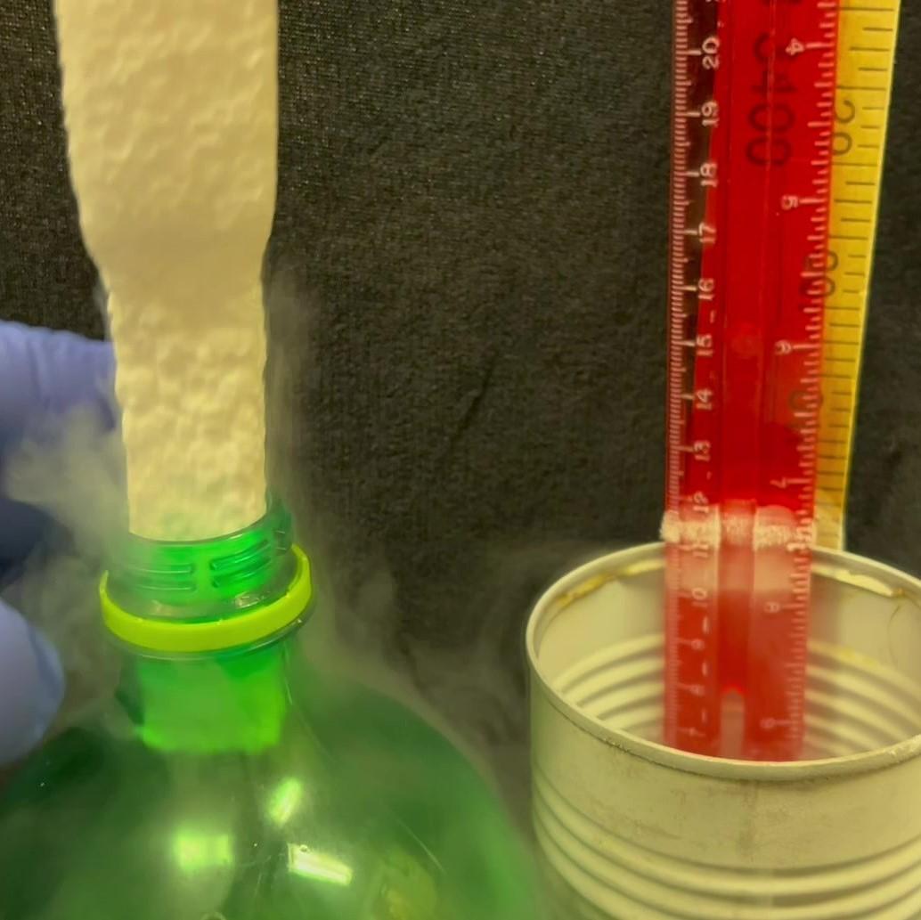 Rectangular polystyrene foam stick shrunken by liquid nitrogen fits into round hole