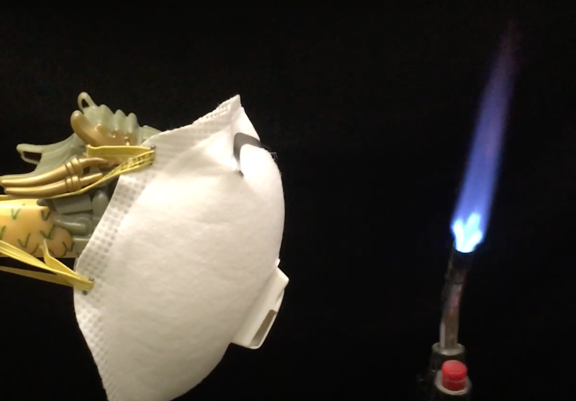dragon wearing mask near bunsen burner flame