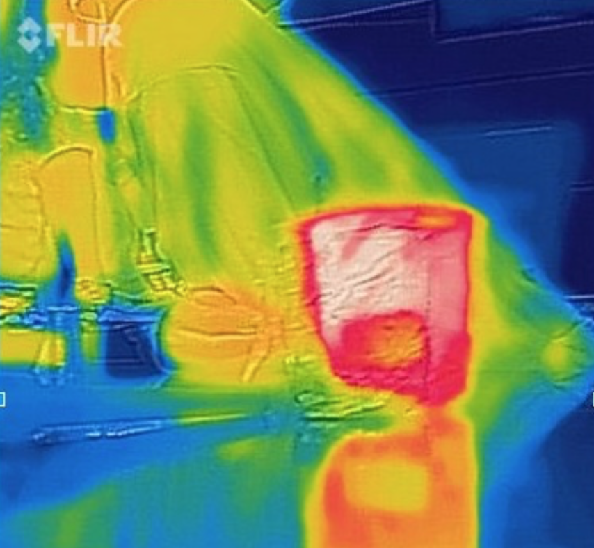 IR camera image of student with beaker at lab counter