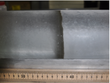 A visible, brown volcanic ash layer within an ice core