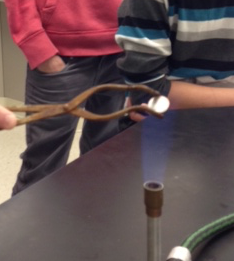 heating a zinc coated penny in a bunsen burner flame